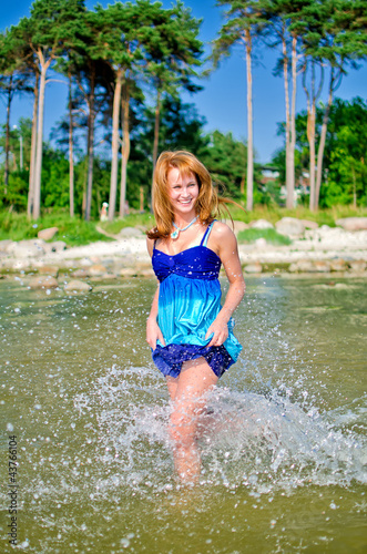 Fototapeta Naklejka Na Ścianę i Meble -  Attractive woman walking in the sea
