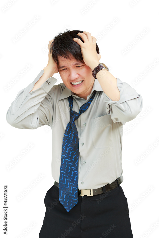 Young business man holding his head in pain against Young business man holding his head in pain against