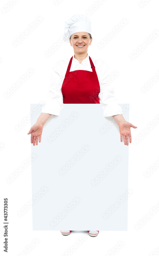 Female cook showing white blank ad board Female cook showing white blank ad board