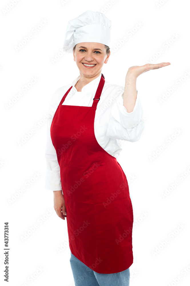 Smiling cook presenting copy space, open palm Smiling cook presenting copy space, open palm