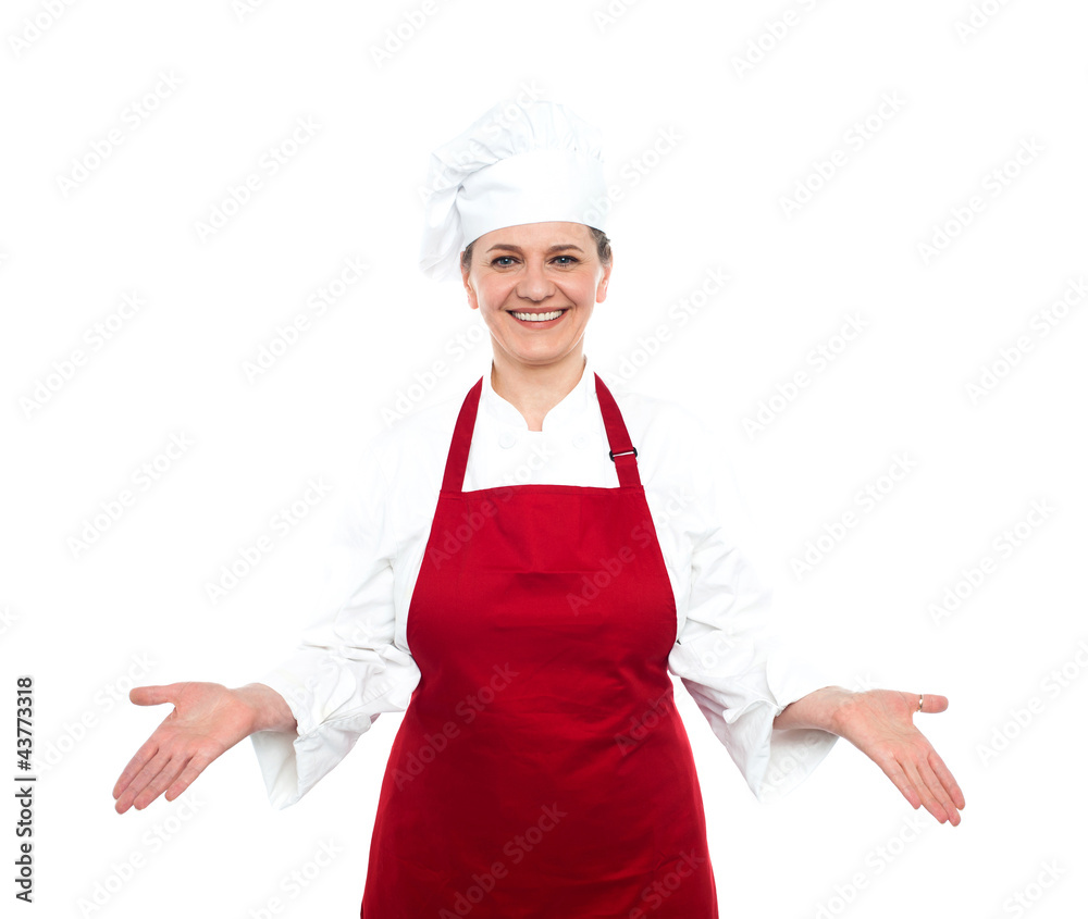 Senior female chef standing with open palms Senior female chef standing with open palms