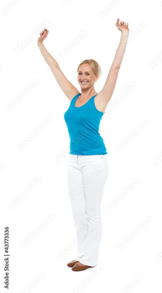 Successful woman posing with raised arms