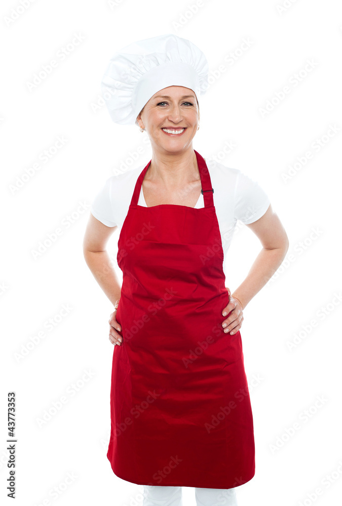 Female cook posing with hands on her waist Female cook posing with hands on her waist
