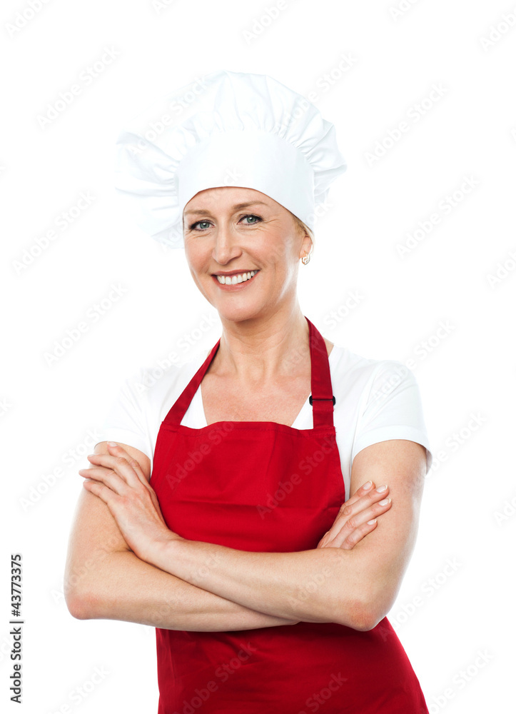 Middle aged female chef posing with crossed arms Middle aged female chef posing with crossed arms