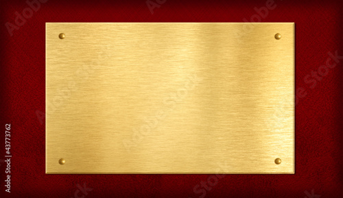 gold plate or plaque on red background photo