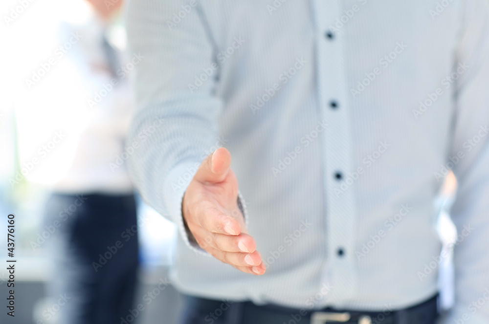 Fototapeta premium A business man with an open hand ready to seal a deal