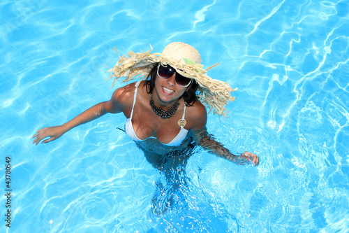 Young woman enjoying a swimming pool