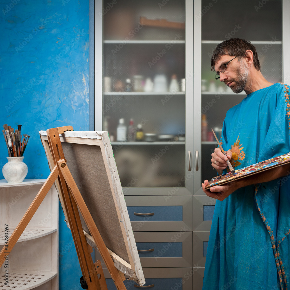 artist paints picture in the studio