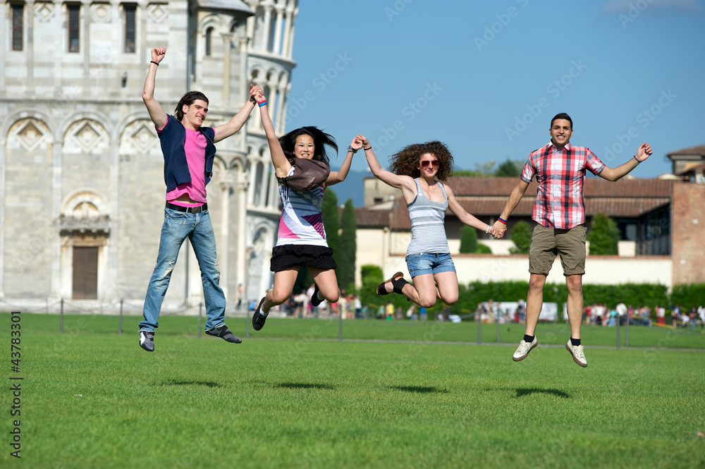Group of Friends Jumping with Pisa Leaning Tower on Background
