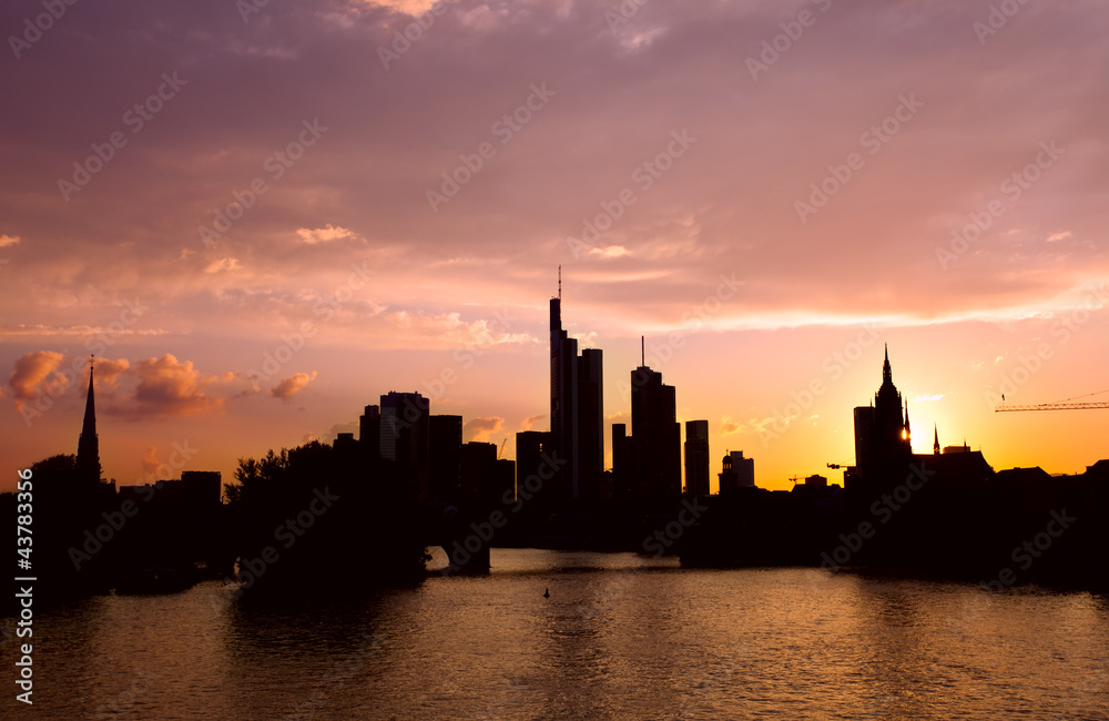 silhouettes of Frankfurt architecture over sunset