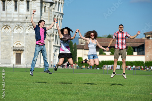 Group of Friends Jumping with Pisa Leaning Tower on Background © Riccardo Piccinini