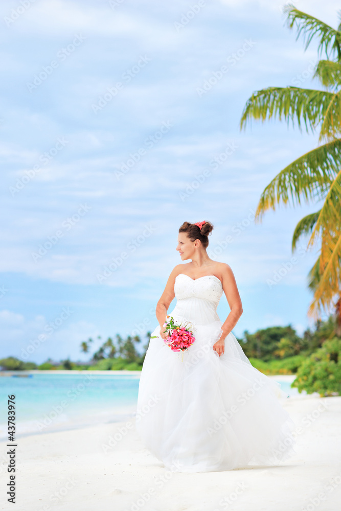 Young bride on a beach in Kuredu resort, Maldives island