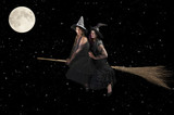 two witches flying on a broom