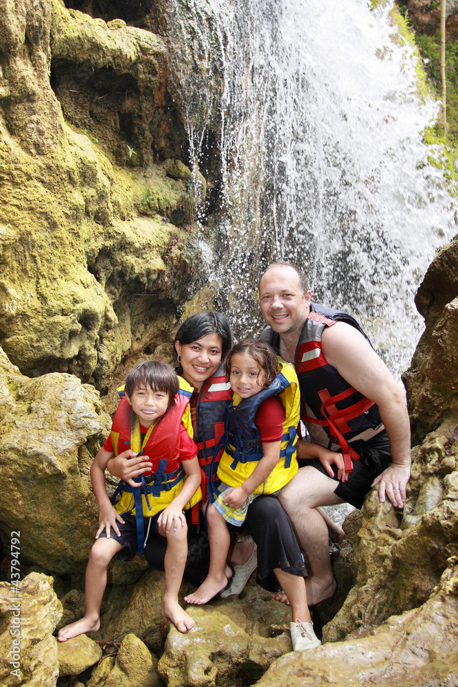 happy family in the waterfall