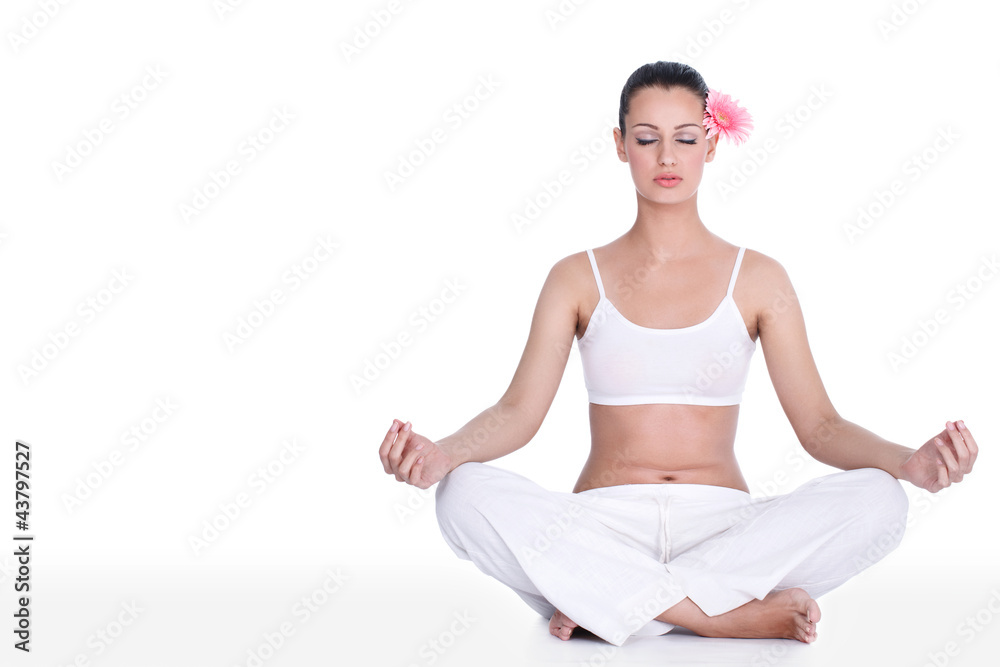 Young woman practicing yoga in the lotus position