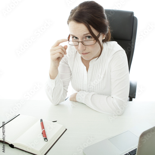 young brunette business woman looking over her glasses