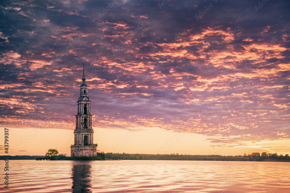 Submerged bell tower in river on a beautiful sunrise