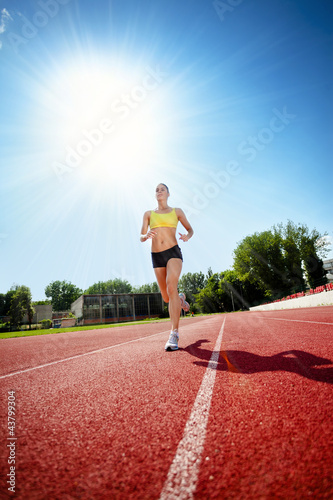 Runner on athletic track © luckybusiness