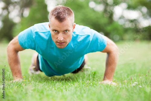 Man doing press ups outdoors