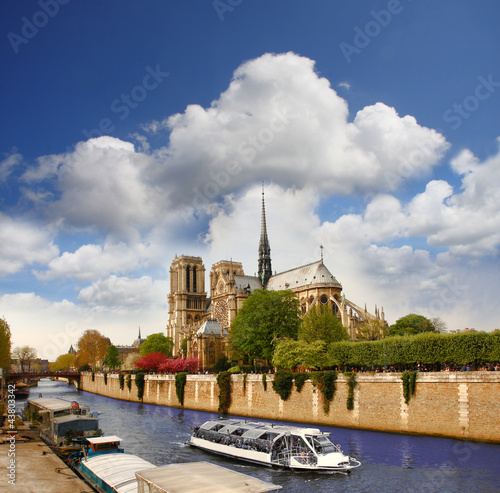 Paris, Notre Dame cathedral with boat on canal, France