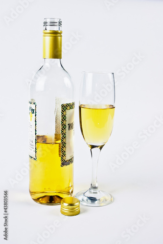 bottle with a glass of white wine