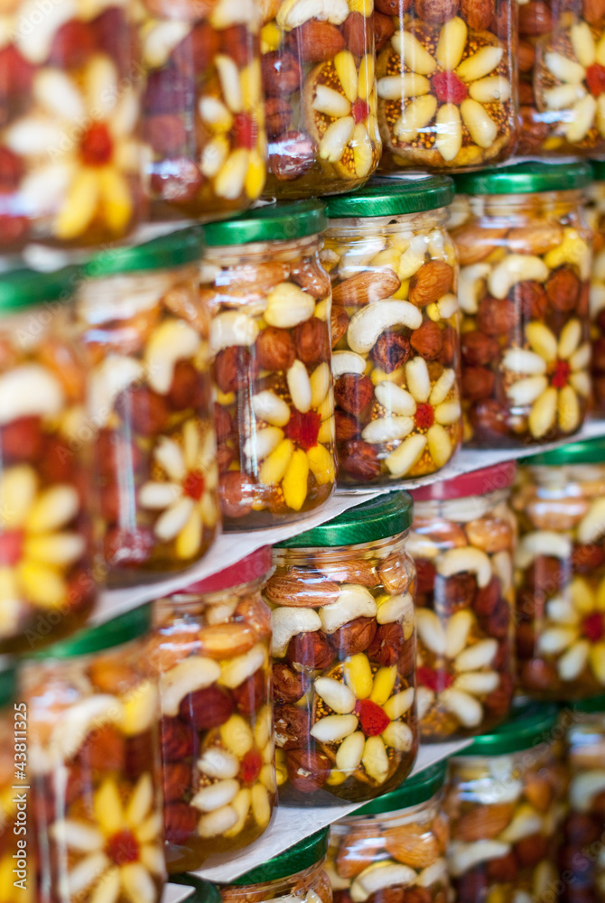 Honey, berry and nuts in bottles