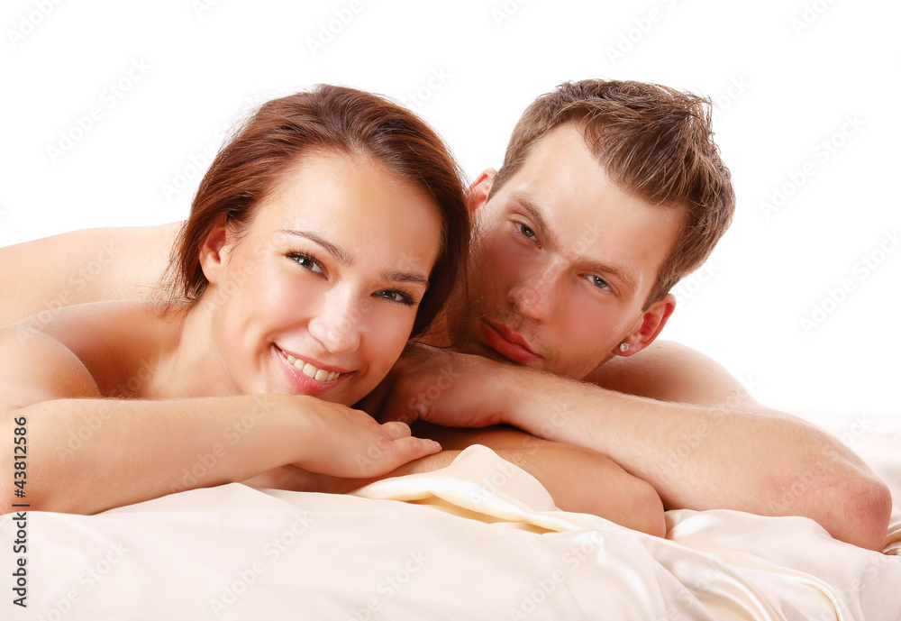 A loving affectionate nude heterosexual couple on the bed A loving affectionate nude heterosexual couple on the bed
