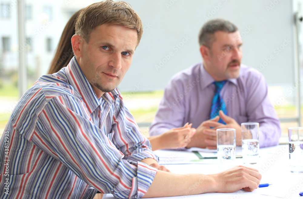 Fototapeta premium young business man attending a meeting with his colleagues
