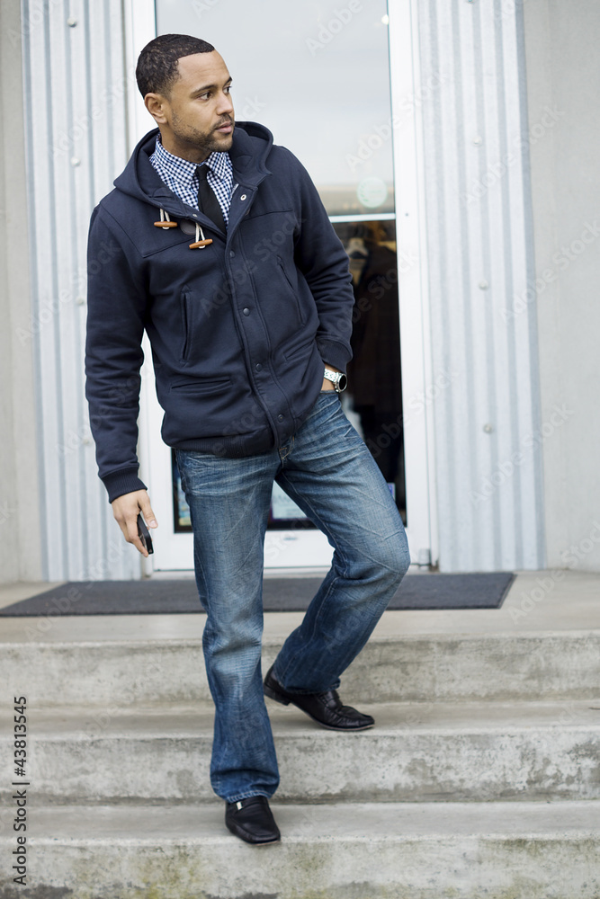 Young black man standing on steps looking right Young black man standing on steps looking right