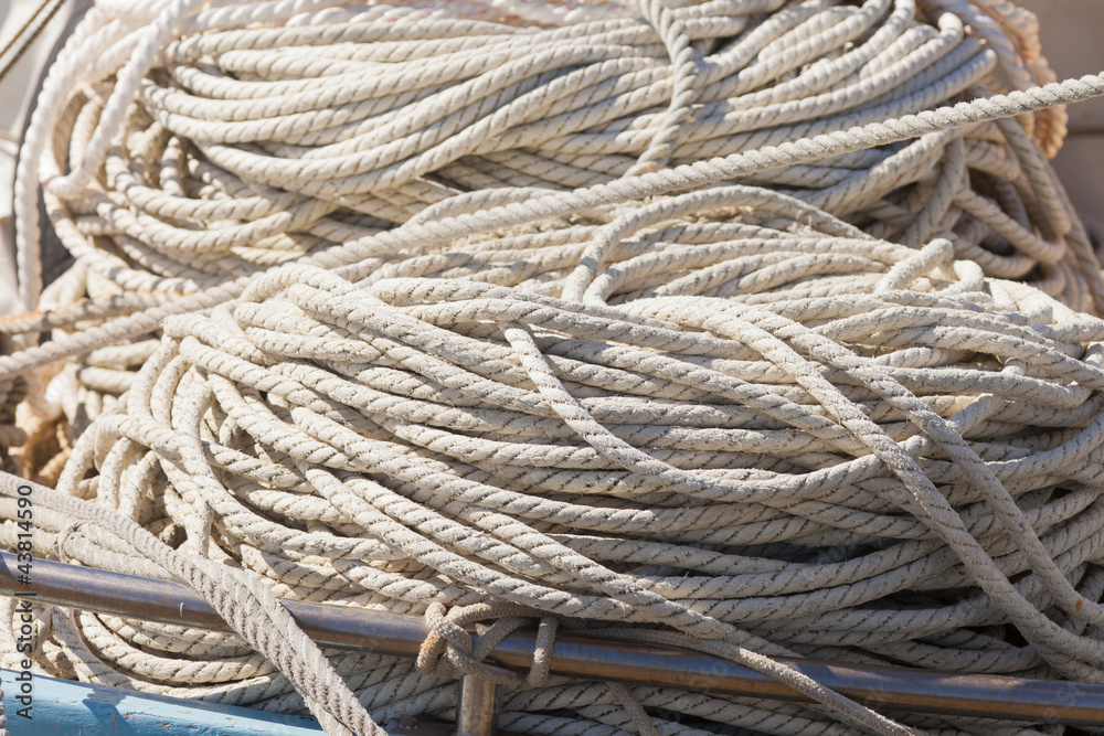 Pile of worn hemp rope background texture pattern.