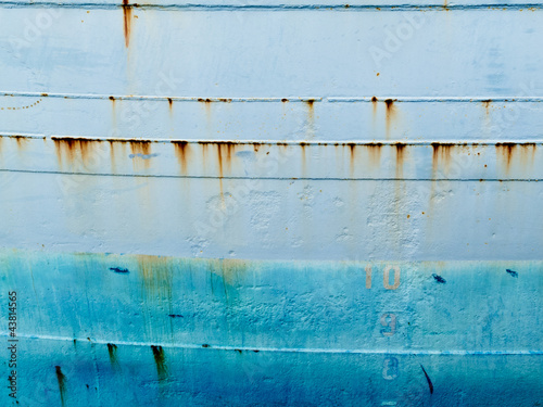 Background of blue grungy steel hull of ocean ship