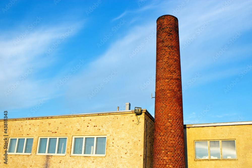 Fototapeta premium Brick smokestack in old industrial building