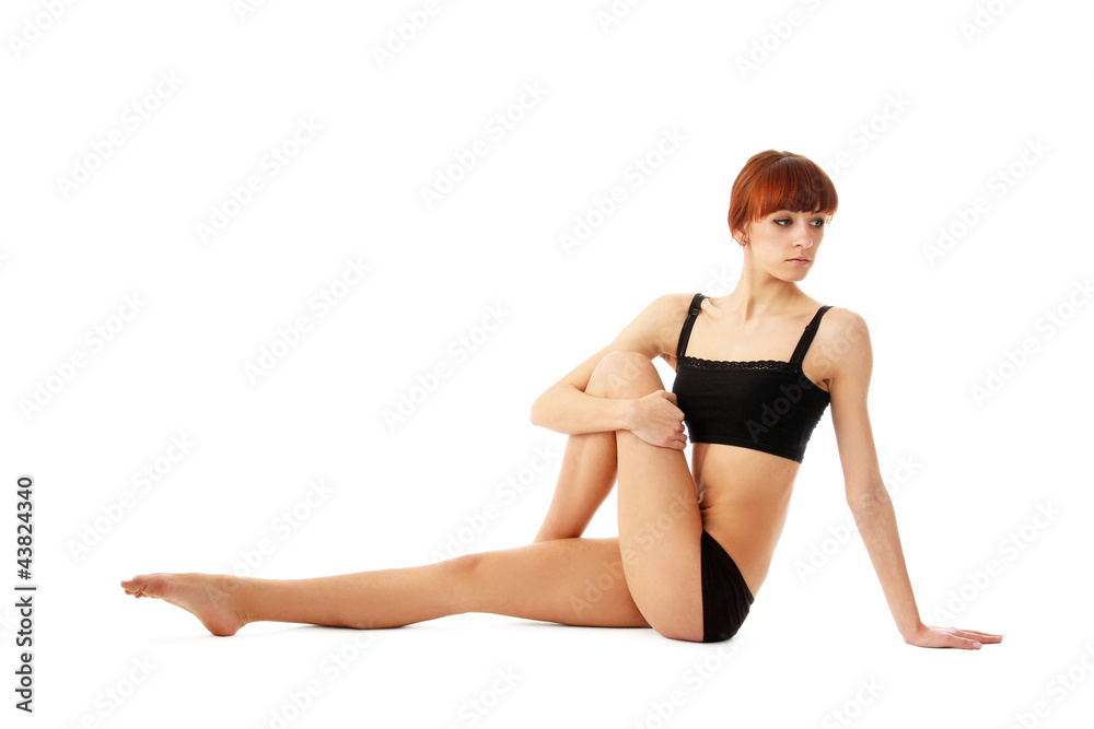 Sport woman sitting on the floor, isolated on white background