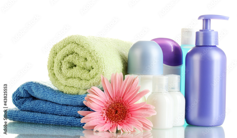 cosmetics bottles with towels and flower isolated on white cosmetics bottles with towels and flower isolated on white