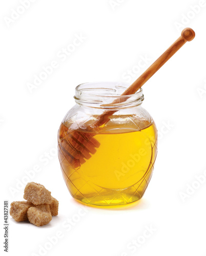Honey with wood stick, isolated on white background