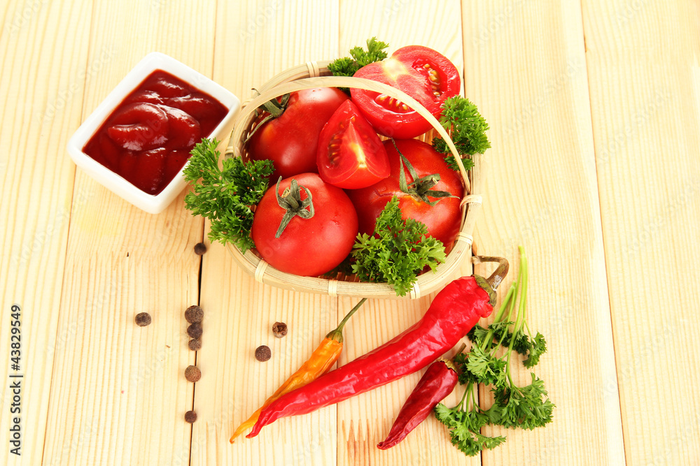 Still life tomatoes ketchup and herbs on wooden table Still life tomatoes ketchup and herbs on wooden table