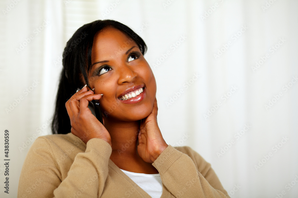 Charming girl looking up and conversing on mobile Charming girl looking up and conversing on mobile