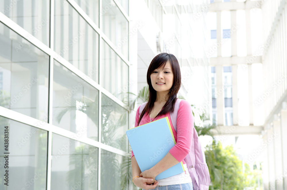 College Student standing outside college building College Student standing outside college building