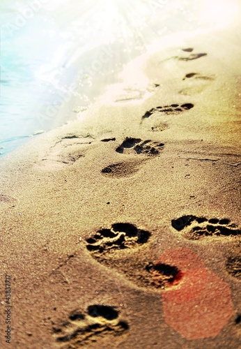 Footprints on the beach sand. photo