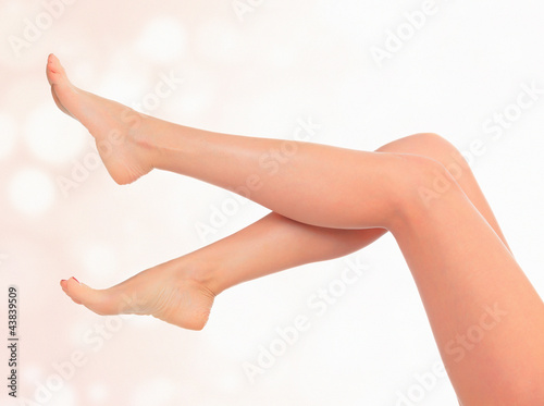 Legs of a woman against abstract pastel background