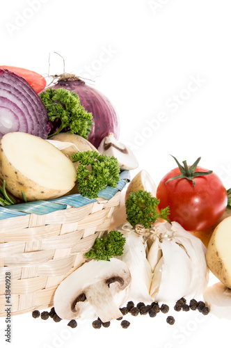 Vegetables in a basket isolated on white