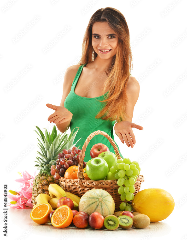 Young woman with assorted fruits in wicker basket isolated Young woman with assorted fruits in wicker basket isolated