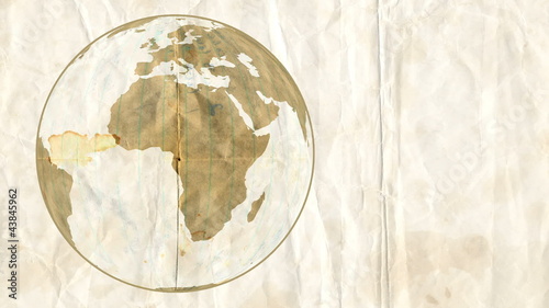Animation of degraded paper Earth, rotating on a crumpled paper.
