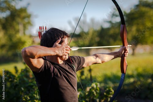 Fototapeta Young archer training with the  bow