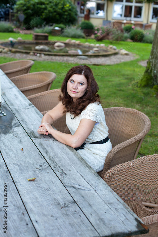 Young beautiful woman sitting in garden restaurant summer Young beautiful woman sitting in garden restaurant summer