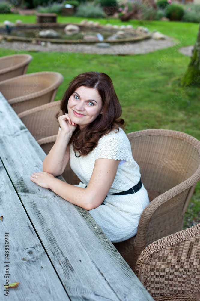 Happy beautiful woman sitting in garden restaurant summer Happy beautiful woman sitting in garden restaurant summer