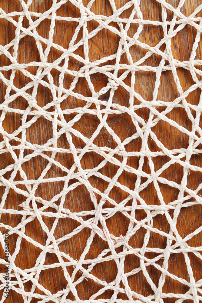 Fototapeta premium Abstractedly looking straw mat on wooden background