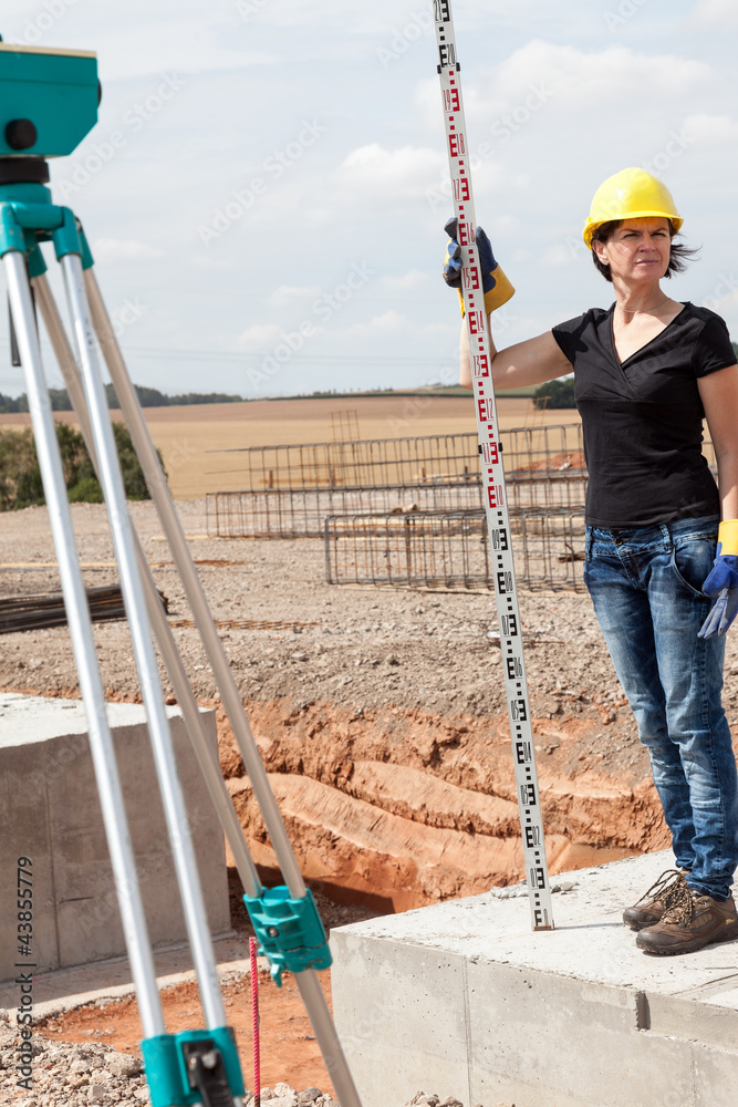 Naklejka premium Construction worker on site at the measure
