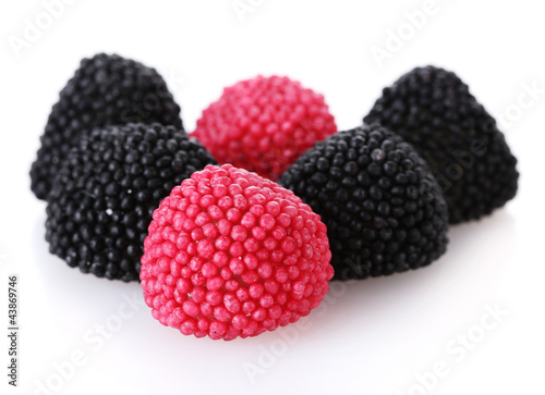 red and black candy berries isolated on white