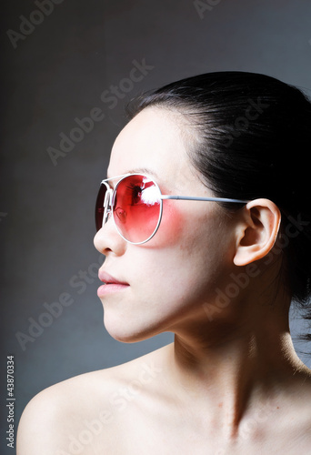 Women in shaw was wearing dark sunglasses